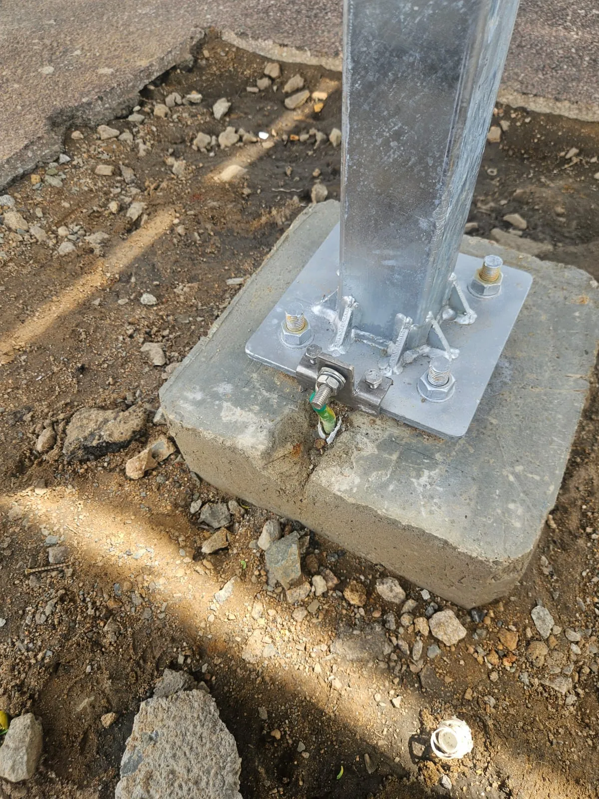 Earthing point bonded to a carport structural baseplate.